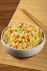 Bowl with instant noodles on the table.