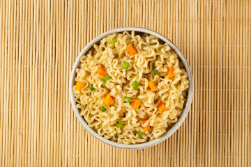 Bowl with instant noodles on the table.