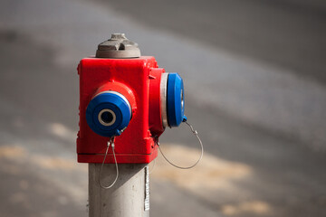 Selective blur on a red and blue fire hydrant from the Serbian firefighters, in a street. It is used as a watersource for fire hazard protection...