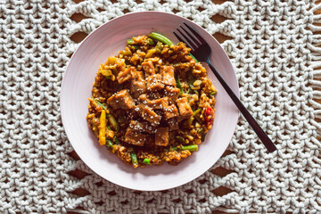 vegan Korean teriyaki sticky tofu with stir fry vegetables, healthy plant-based food