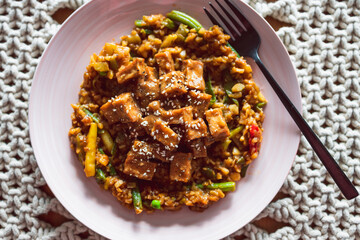 vegan Korean teriyaki sticky tofu with stir fry vegetables, healthy plant-based food