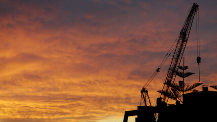 sunset over the city and construction
