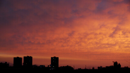 Fototapeta premium sunset over the city and construction