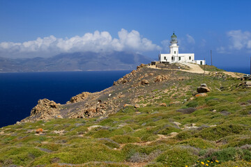 Fototapeta na wymiar View of Mykonos Armenistis Lighthouse with blue sky and sea, Mykonos, Greece 