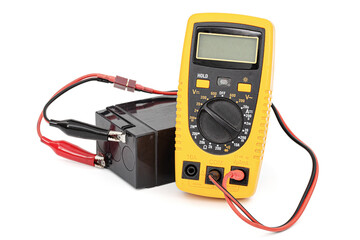 Testing an acid rechargeable battery with a measuring instrument isolated on white background