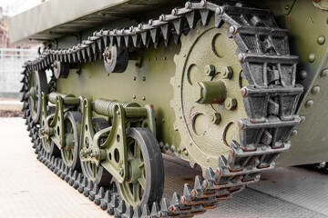 Tank of the Second World War. Track armor close-up. Black track link and large rubberized rollers....