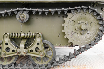 Tank of the Second World War. Track armor close-up. Black track link and large rubberized rollers. Tank chassis. The tank stands on a pedestal.Russia, May 9, 2021. Detail of a tracked tank close-up.