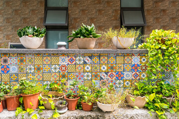 Fototapeta na wymiar Decorative colorful ceramic tiles on a house balcony with flowers