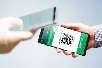 Vaccine passport scanning, Hand of a man show his vaccination and health status proof that a he has been immunized against COVID-19 to the airline staff before he checked-in and boarding. Technology.