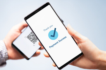 Hand of a customers with smartphone scanning QR Code payment from retailer. Cashless society, Contactless, Electronic wallet, Mobile app, Internet Technology, Smart solution, Digital money,  Close up.