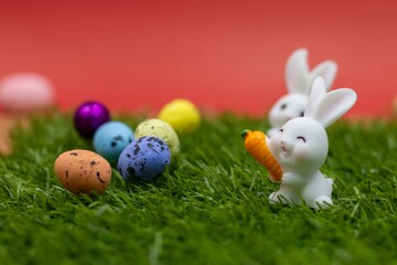 Rabbit with Easter eggs on red background