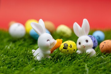 Rabbit with Easter eggs on red background