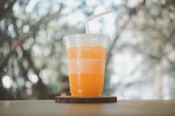 Fresh orange juice in plastic glass. Healthy drink.