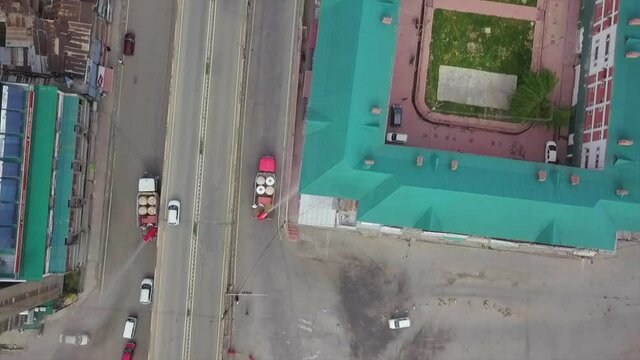 Top view Drone videos of covid fumigation vehicles trucks and frontline heroes wearing  white kits on streets empty roads of srinagar city Kashmir India.