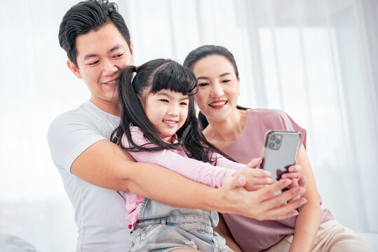 Closeup - Happy asian family taking selfie at home.