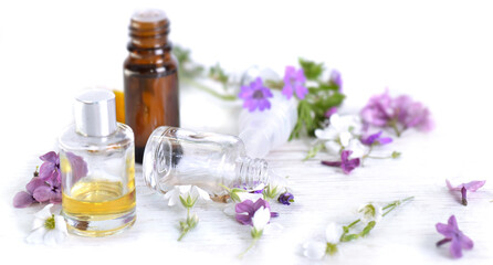 Fototapeta na wymiar essential oil and freshness flowers in bottle on a table