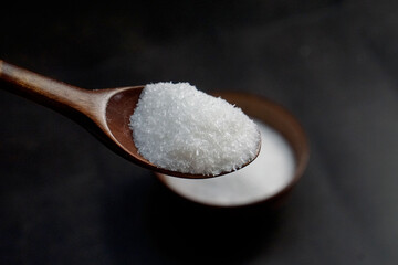 monosodium glutamate, MSG on wooden spoon