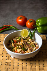 Paneer or cottage cheese cubes minced with capsicum and vegetables served in a bowl.
