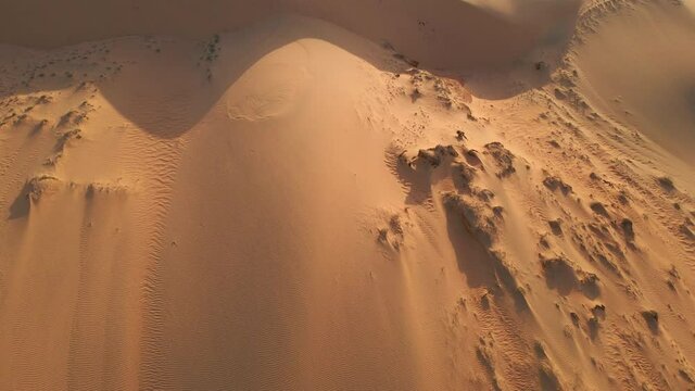 Aerial top-down view on red desert dunes. Desertification concept. Climate change