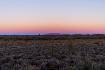 Panoramic view of Kata Tjuta (Mount Olga) on the horizon at sunrise.