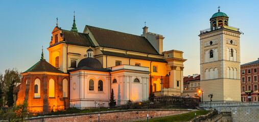 Fototapeta na wymiar Evening view of St. Anna academic church, kosciol Sw. Anny, at Krakowskie Przedmiescie street in Starowka Old Town historic disrict of Warsaw, Poland