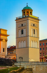 Obraz premium Evening view of Bell Tower aside St. Anna academic church at Krakowskie Przedmiescie street in Starowka Old Town historic disrict of Warsaw, Poland