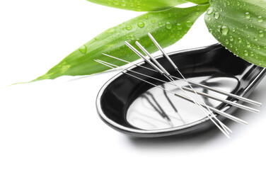 Stand with acupuncture needles on white background