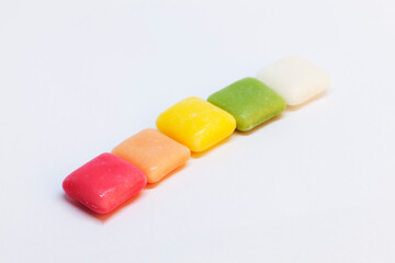 chewy candy in the colors of the rainbow on a white background