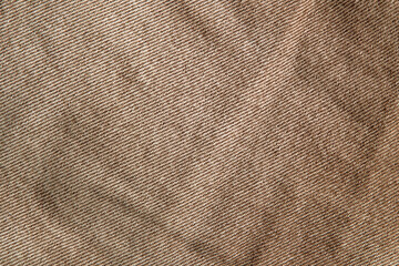 fabric grunge background, real cotton denim brown, wrinkled, frayed, close