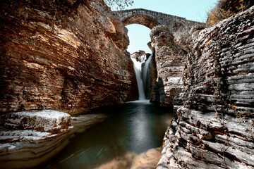 Pogoni, Epirus, Greece. The bridge of Gretsi. Arch stone bridge in mainland Greece. Waterfall...