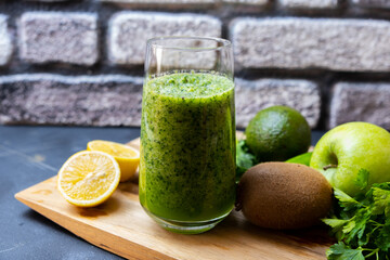 Healthy green smoothie in glass on black background.Detox, vegan, vegetarian healthy vegetable drink.
