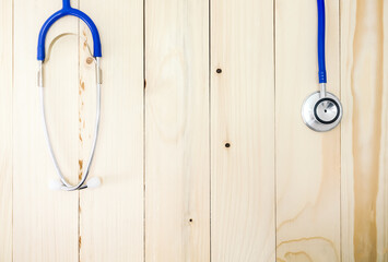 Hanging blue stethoscope. Beautiful pattern pine background. There is a space in the middle of the morning light concept thank you, doctor.