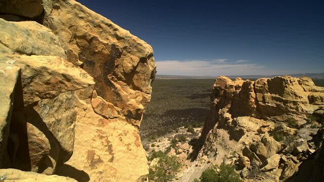 Sandstone Bluffs, El Malpais National Monument in the desert of New Mexico is a dramatic landscape made of Dakota Sandstone that contrasts with dark lava flows farther below.