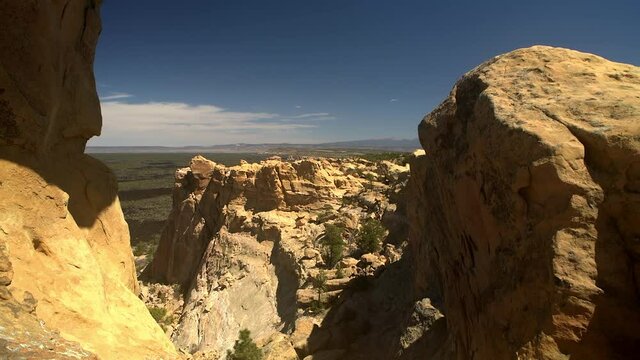 Sandstone Bluffs, El Malpais National Monument in the desert in New Mexico is a dramatic landscape made of Dakota Sandstone that contrasts with the dark lava flows farther below. View of Mount Taylor.