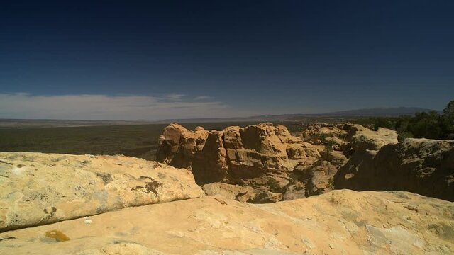 Sandstone Bluffs, El Malpais National Monument in the desert of New Mexico is a dramatic landscape made of Dakota Sandstone that contrasts with the dark lava flows beyond. View of Mount Taylor.