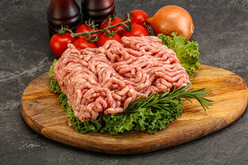 Raw pork minced meat over board