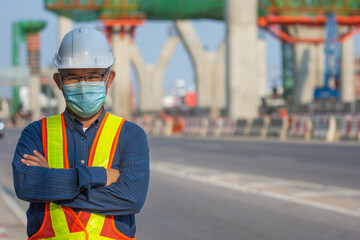 Fototapeta premium Portrait senior Asian man wear face mask standing on site construction background , Old man wear mask protect coronavirus covid19