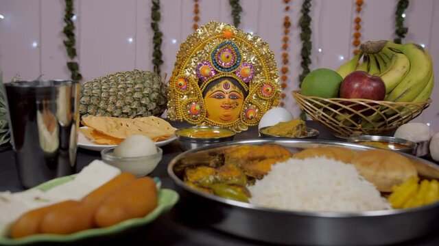 Zoom in shot of a Bengali Prasad/Bhog placed in front of Goddess Durga's idol. Beautifully decorated traditional Bengali food offered in the temple of Ma Durga during the Durga Puja festival