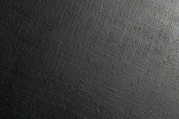 dark creative background: black primed linen canvas, uneven lighting, toning
