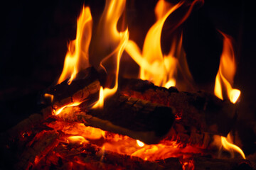 A fire burns in a fireplace, Fire to keep warm. Logs burning in a fireplace