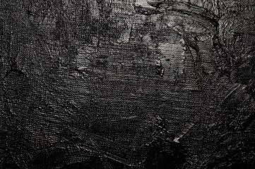 Dark creative background - rough linen canvas unevenly covered with black primer, reflections of...