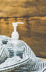 Hand sanitizer bottle in towel wooden background concept covid-19