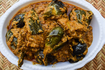 Delicious Indian brinjal curry specially made in south india known as Gutti Vankaya an Andhra party style side dish with peanut,sesame gravy. Eggplant or Aubergine stuffed masala. baingan ki sabzi - obrazy, fototapety, plakaty