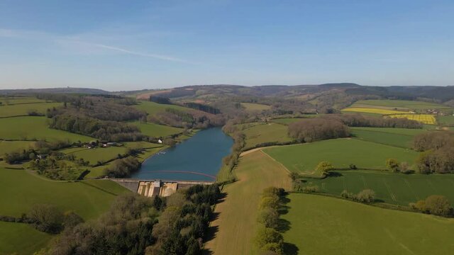 4K flying over hawkridge reservoir, drone moving forward over the green tree in front of the water dam wall, 60fps.