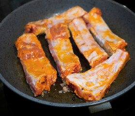 
Pork ribs meat close-up in a frying pan