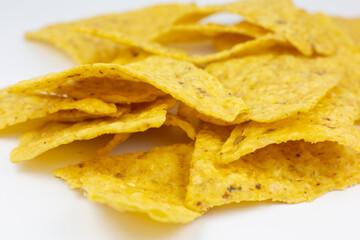 Close up, Triangular chips, mexican nachos, on white background. Perfect Tasty spicy snack for a beer.