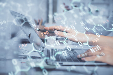 Double exposure of woman hands typing on computer and formula hologram drawing. Education concept.