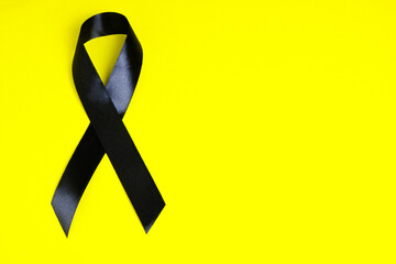 Black ribbon on yellow background is symbol melanoma, symbol of memory victims Stalinism and Nazism...