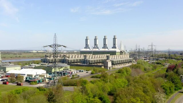 Flint power station in Wales UK. Long slow drone shot with cinematic tilt up.