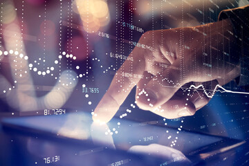 Multi exposure of man's hand holding and using a digital device and data theme drawing. Innovation...